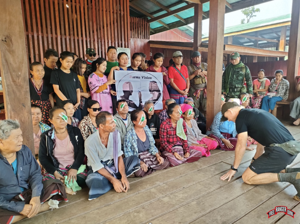 Dave Eubank praying for eye patients, post-surgery. Praying for the patients is a usual practice of Dr. Nay Hser's. 