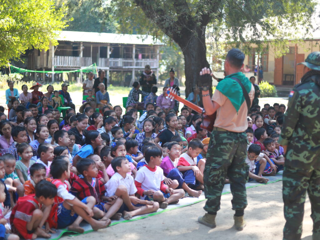 Ranger chaplain leads kids in a song.