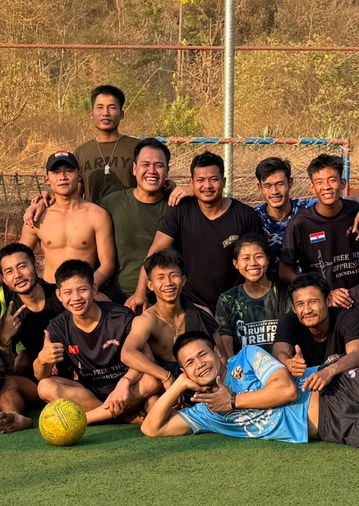 Oo Reh, back center, playing soccer.