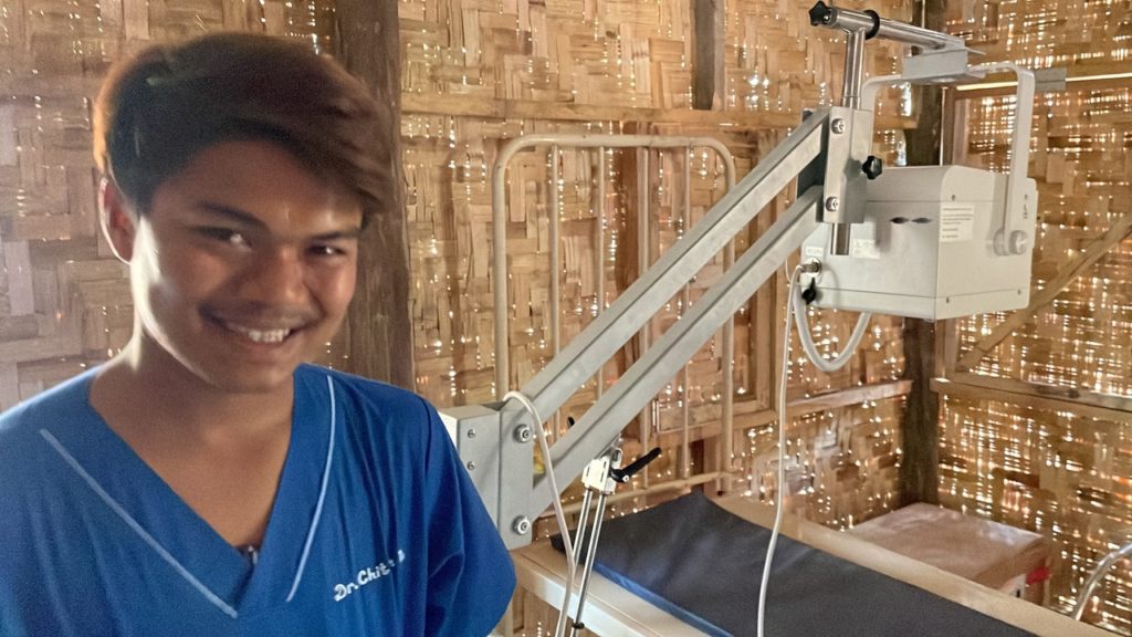 Doctor in a hidden jungle hospital with X-ray machine we donated.