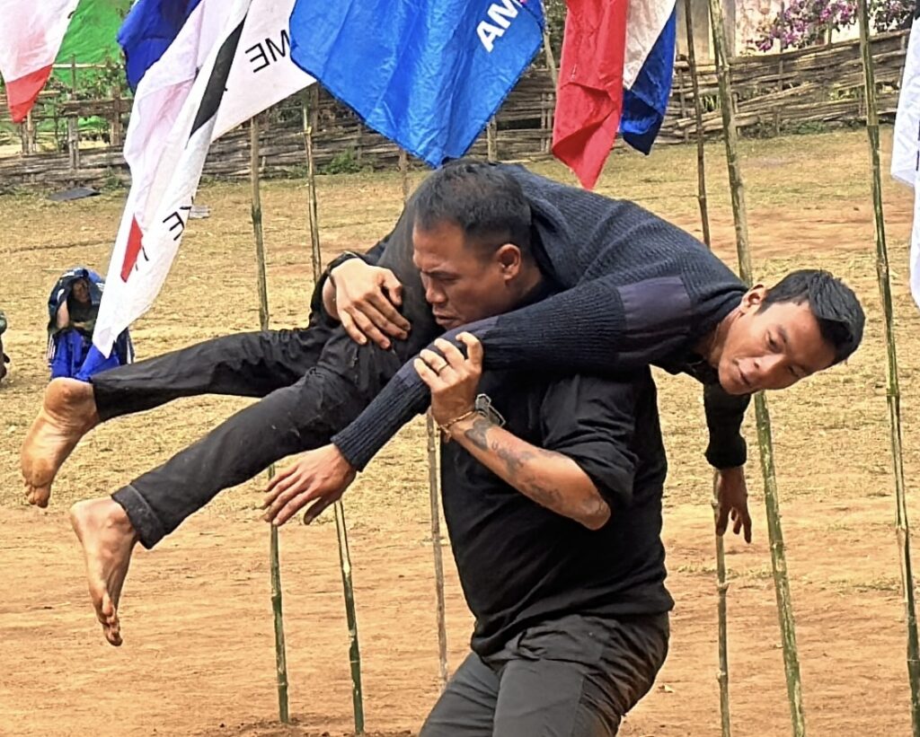 Yar Su and another Ranger, Aung Zay Ya, demonstrate how to carry your wounded friends during a kids program.