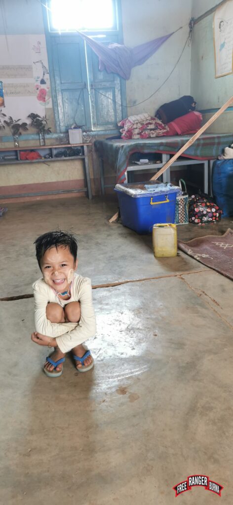 Young girl smiling in her living area.