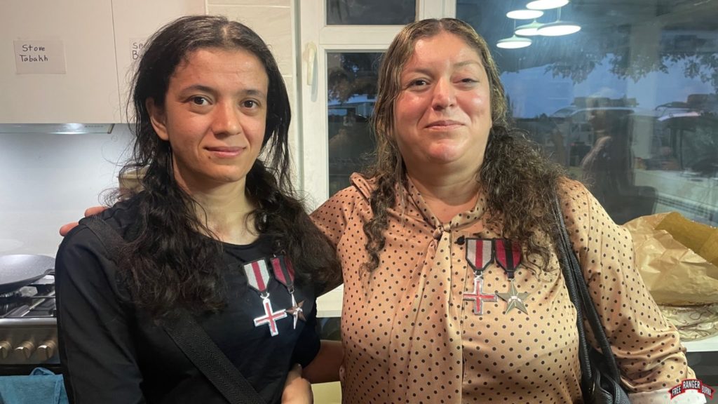 Sousan (left) and her mother, reunited, wearing the medals FBR awarded them for bravery and suffering.