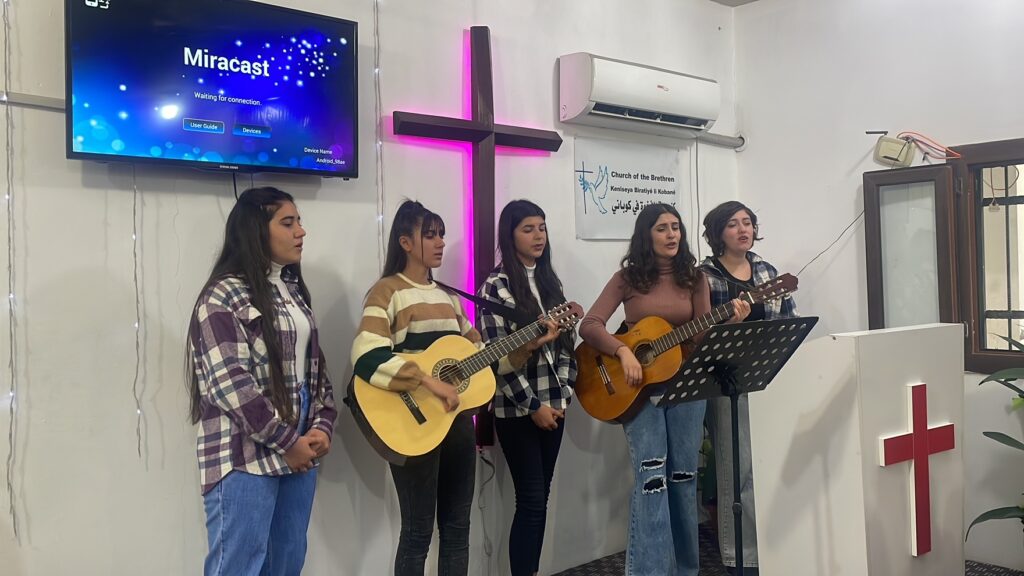 Harmony transcending borders: Young women singing and leading worship at the Church of the Brethren in Kobane, Northeast Syria.