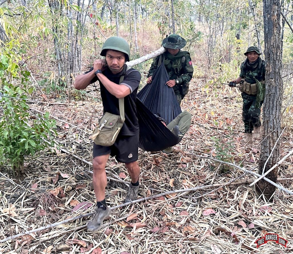 Rangers carry wounded under fire.