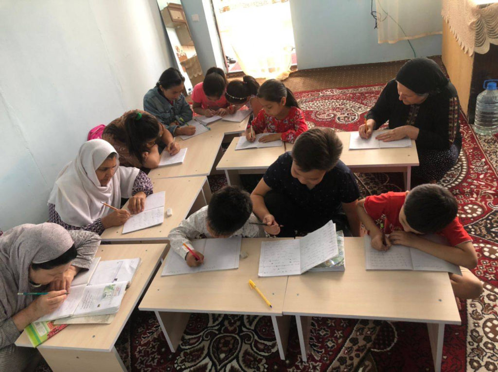 Reading and writing class for illiterate Afghan children and women.