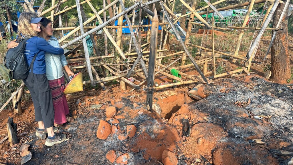 Karen Embraces Anyae Say Bee in the Wreakage of her Home .