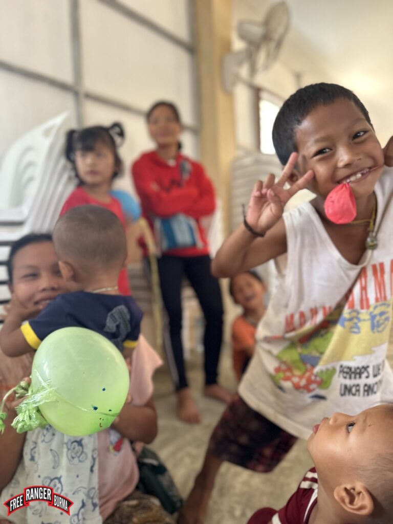 Children playing with balloons brought by Rangers.