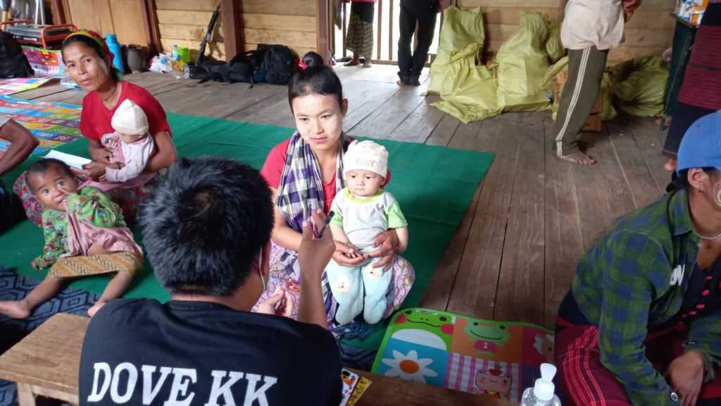 Mother and child consult a Dove KK medic during a joint medical clinic with FBR.