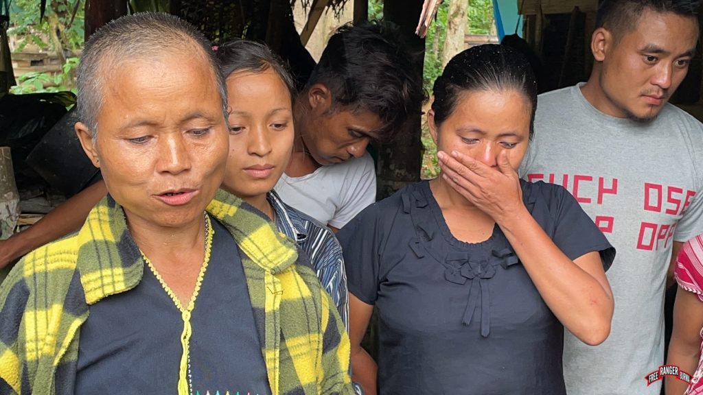 Saw Pah Kee Bu's wife tells their story as her oldest daughter cries.