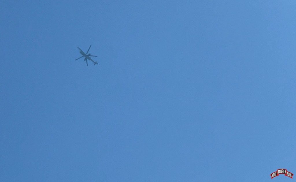 Burma Army helicopters fly overhead. 