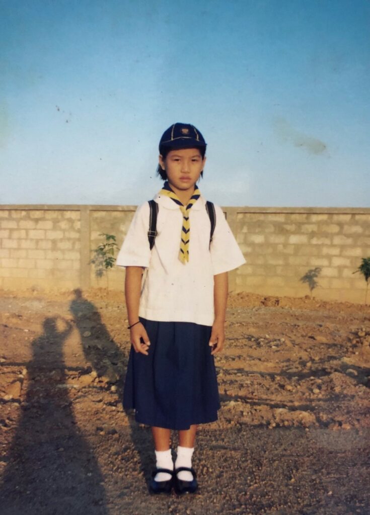 Nu in her school uniform as a young girl in Thailand.