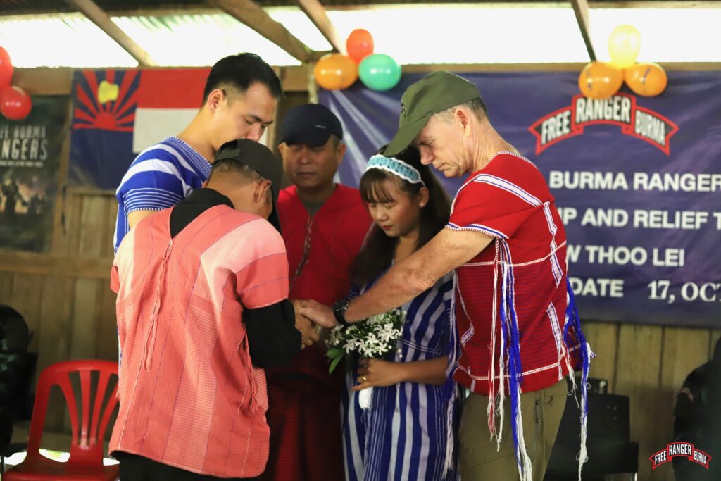 Praying over the newly-married couple.