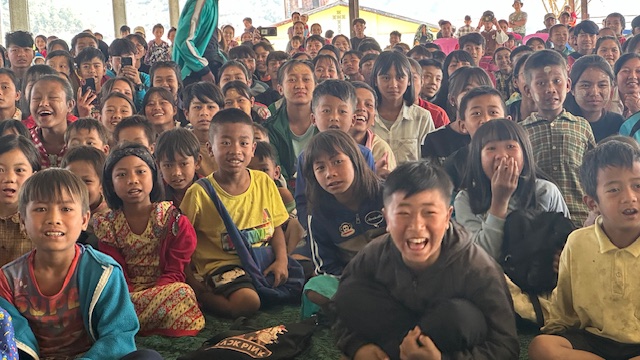 IDP kids laugh at a skit during a GLC program.