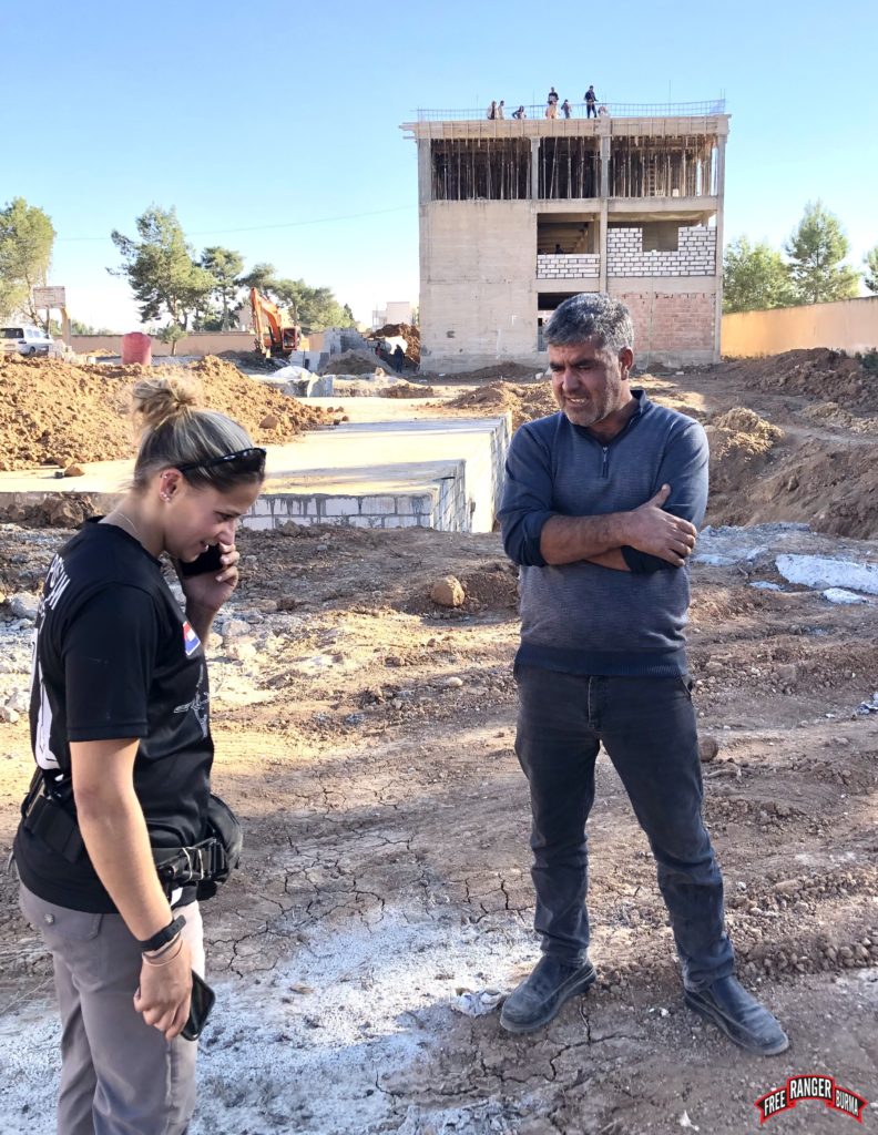 Heidi talking to the builder and contractor for the new hospital.