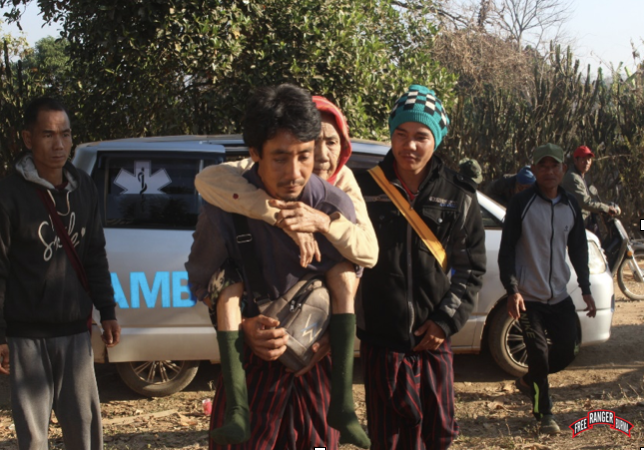 Villager being carried to receive eye treatment in Karenni State, Burma 2023.