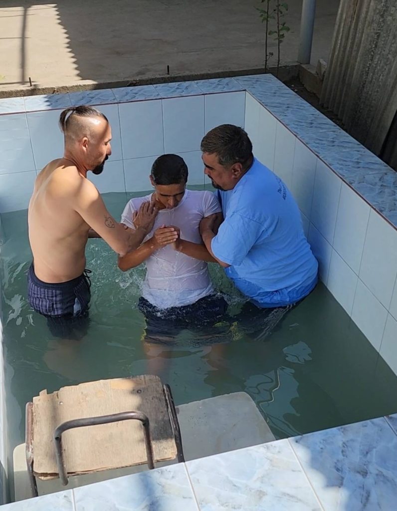 Afghan refugee being baptized.