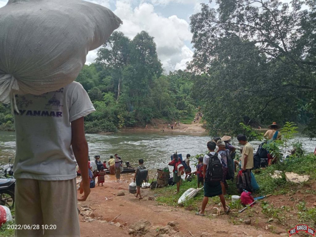 Fleeing villagers crossing the Bawgata River. 