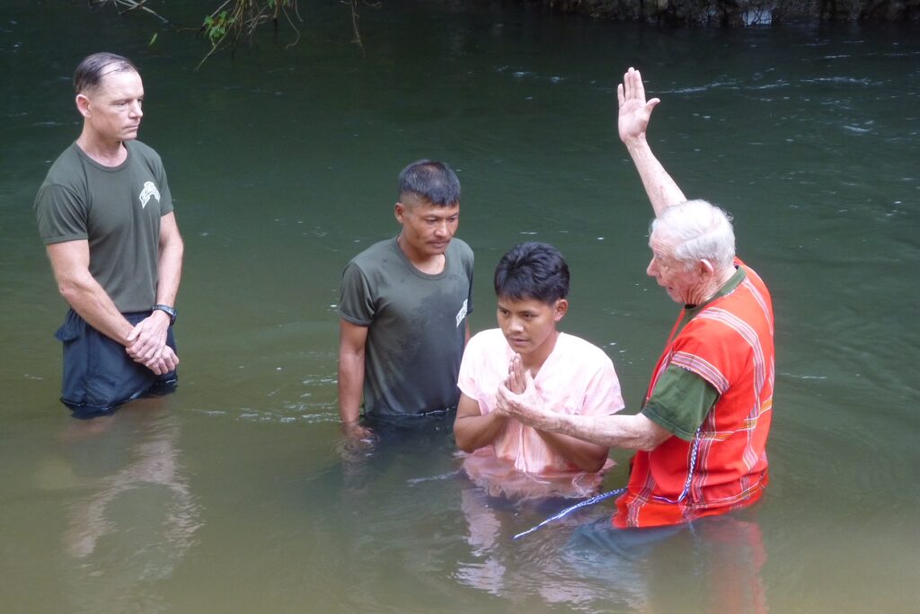 Allan helping to baptize Rangers at our camp.