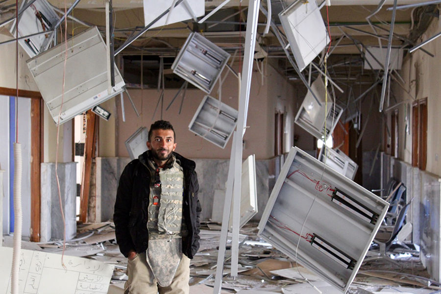 Shaheen in the ruins of the outpatient building at Salam Hospital. Photo courtesy of Riley.