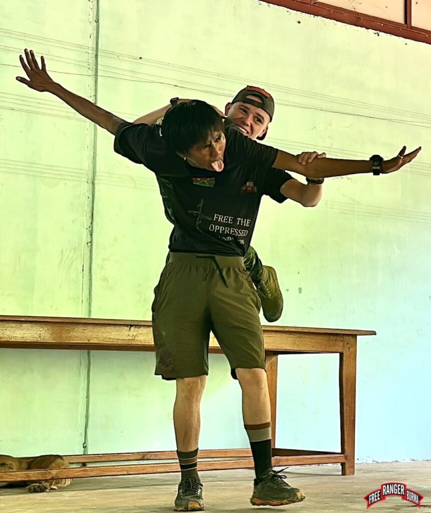Jack pretends to learn to do swing-dancing for a group of children. This photo was taken immediately before another airstrike came in, yet Jack maintained his calm, helped the children get to safety, and then got everyone together again after the airstrike was over.