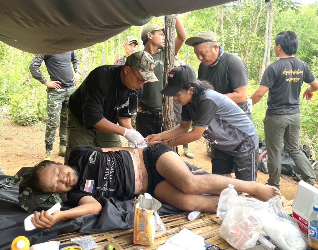 Sliverhorn being treated after being wounded while helping in Karenni State. 