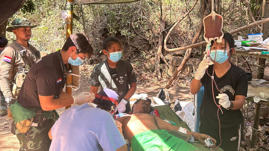 Ranger giving blood to a Burma soldier in Karenni as our doctors save his life.
