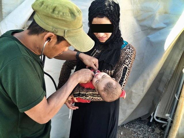 Toh, Karen medic, treats sick baby.