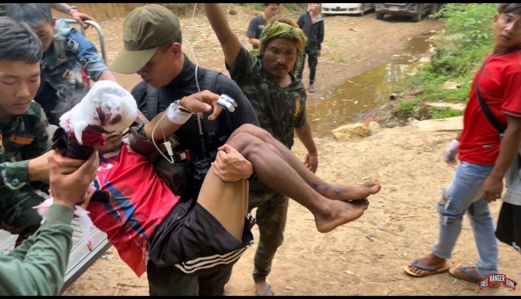 Karenni Ranger teams help evacuate a civilian injured by a landmine explosion.