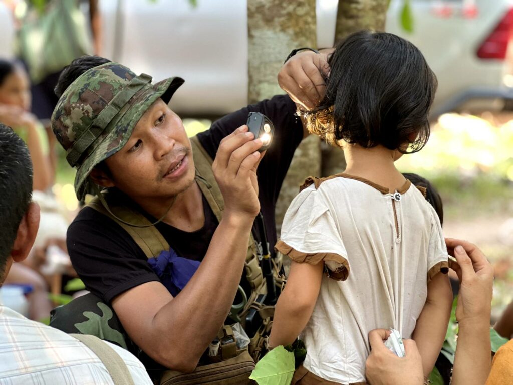 Ranger treats IDP child at GLC clinic.