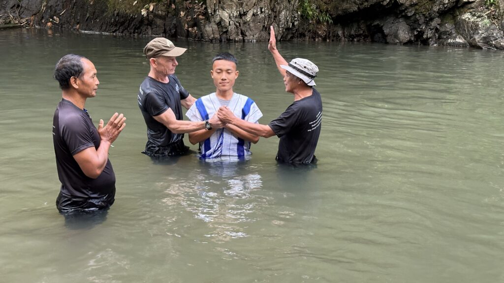 Lin Htet Aung being baptized by David Eubank, Reverend Edmund, and Doh Say. Doh Say was the senior leader in charge of the Relief Team Chaplain course this year.