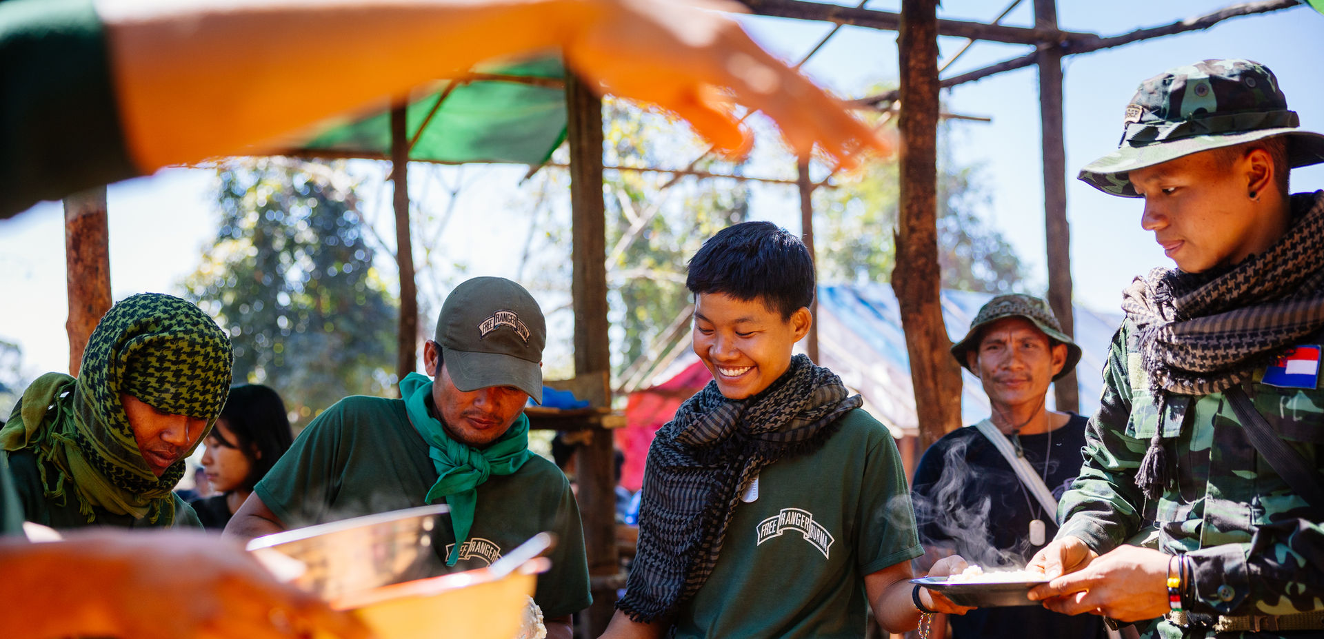 A group of humanitarian aid workers from Burma share a meal together