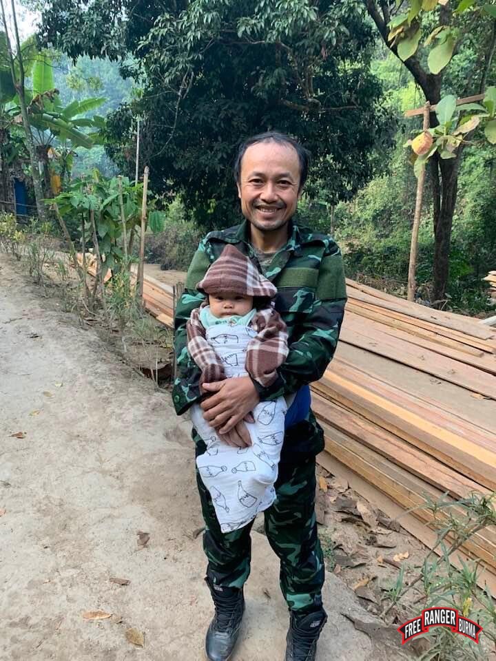 Silverhorn holding one of his children.