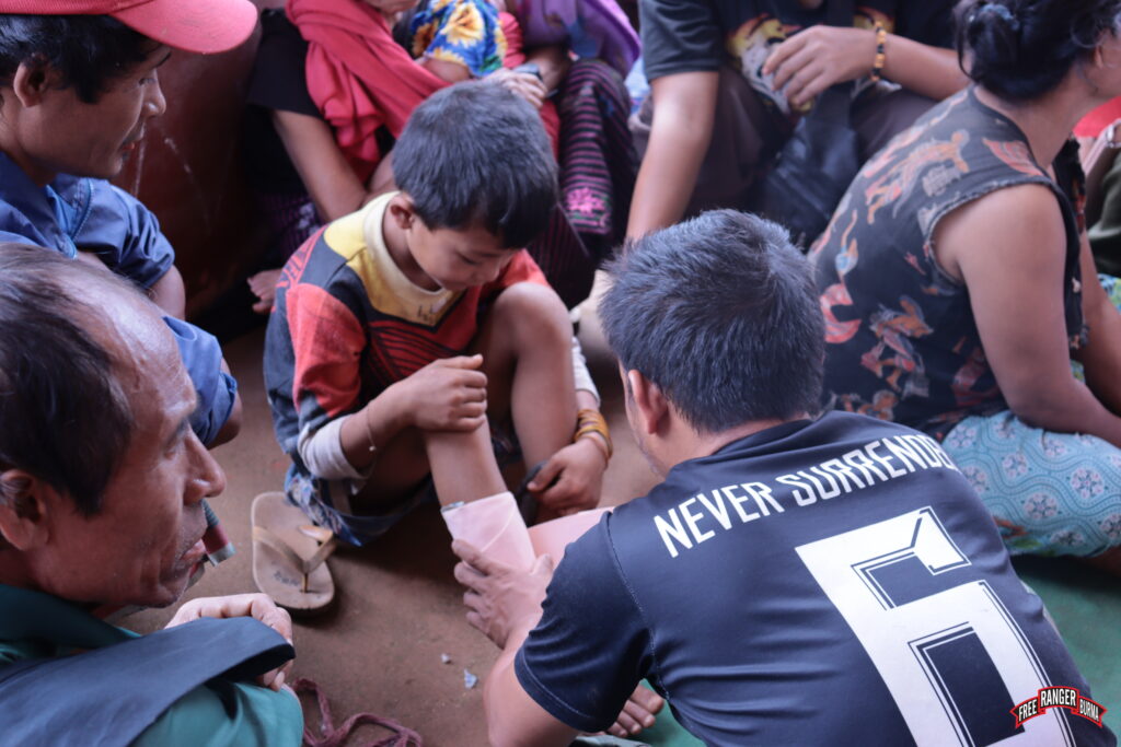 Ranger cares for young IDP boy.