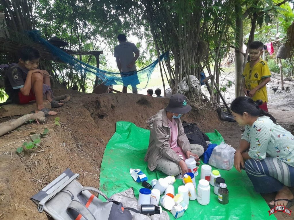 The FBR team giving medical care and mosquito nets to villagers in hiding.
