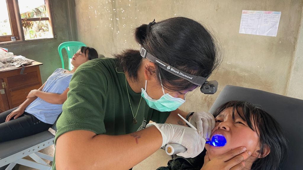 Burman medical student, now FBR medic, gives dental treatment to IDP.