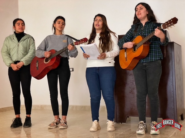 Kurdish Christians from Kobani sing at the church during the program