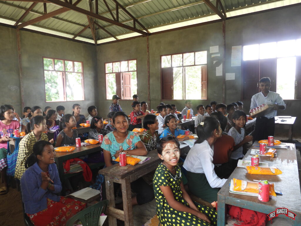 Children smile as they receive snacks during September 2023 mission.