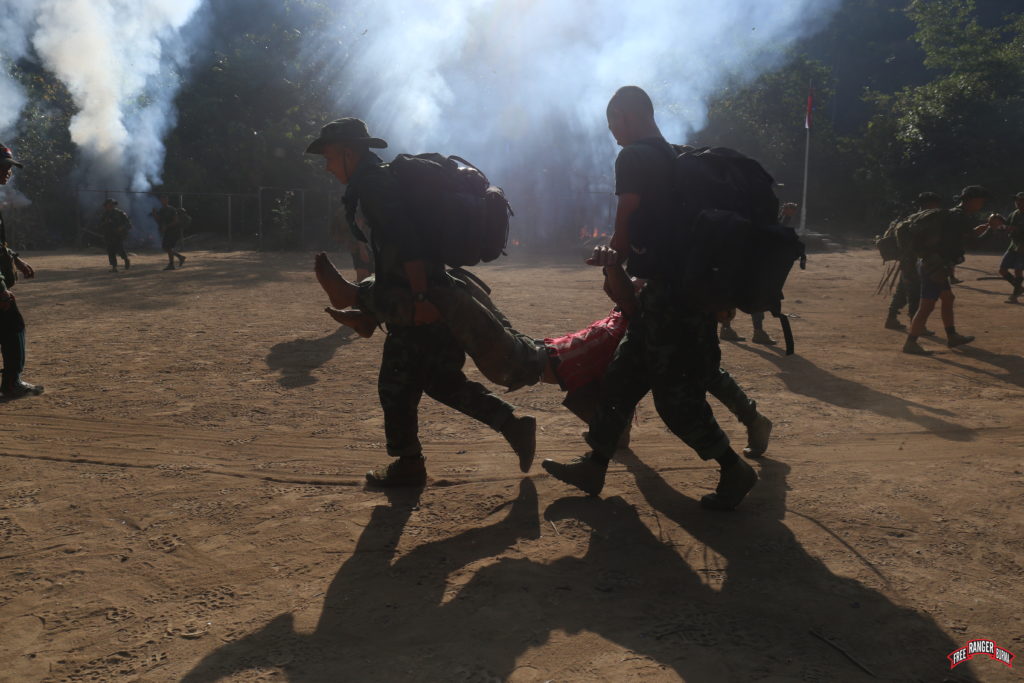 Rangers practice rescuing villagers during a village attack simulation exercise.