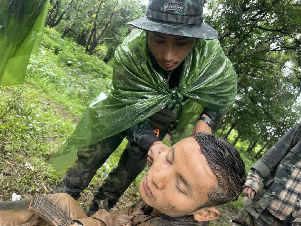 Ranger medic treating patient near the fighting.