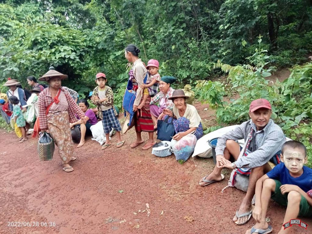 Villagers resting as they flee.