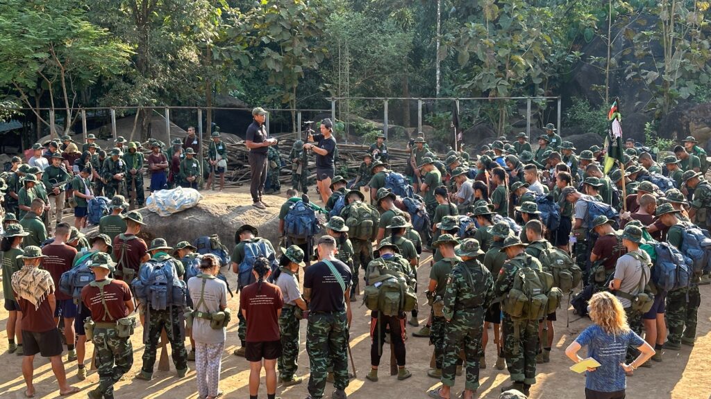 Doh Say sharing about Jesus with the picture chart that Allan gave him.