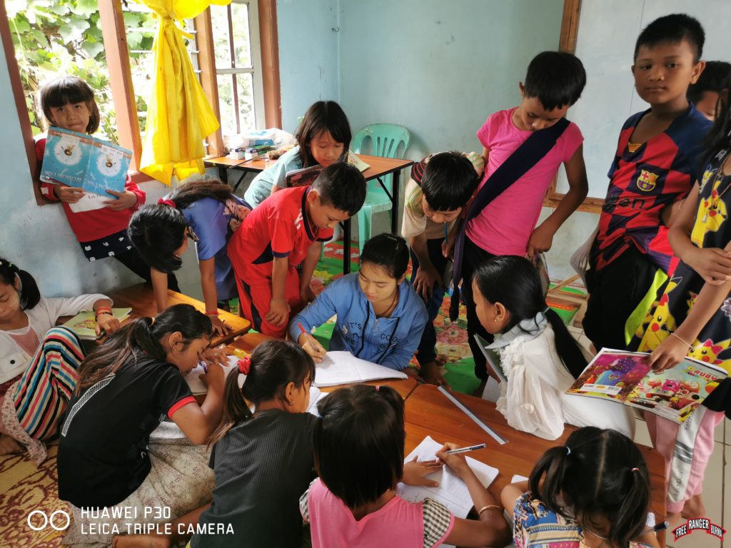 IDP students completing a school assignment. 