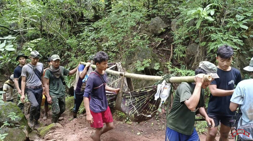 The Karenni Ranger team carries a wounded resistance fighter to a hospital where he can receive the care he needs.