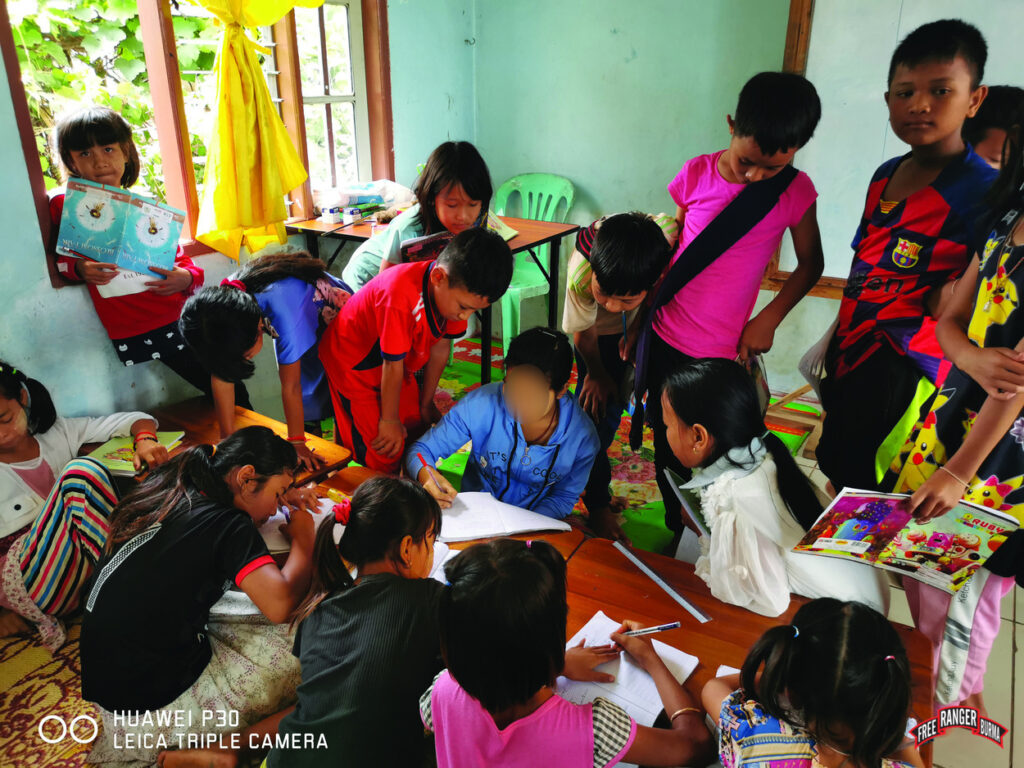 Nu teaching IDP children in Shan State.