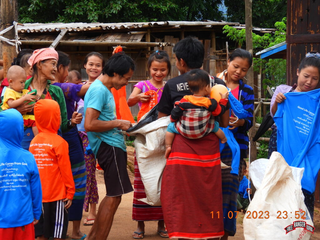 Villagers smile as they receive their GLC shirts.