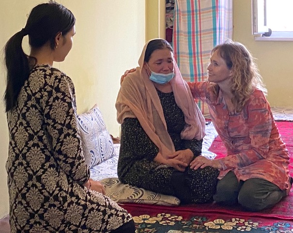 Karen comforts Afghan refugee