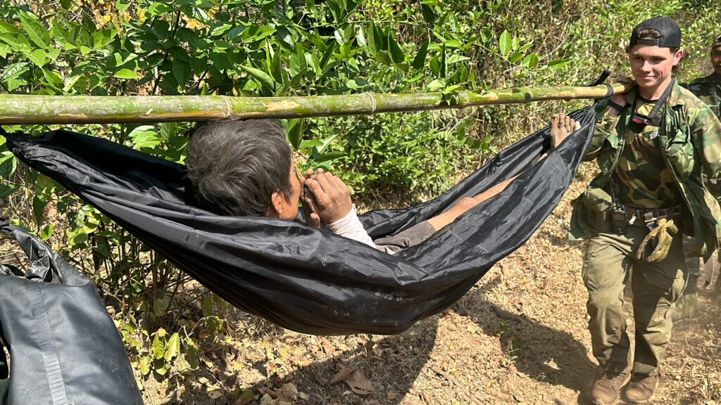 FBR team carrying a wounded Burma Army soldier as Burma Army planes bomb us. 