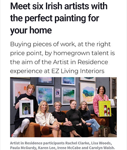 Karen Lee holding her iconic Poolbeg Painting in yellow.