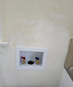 Finished laundry box installation with water supply valves and drain connection in Altadena
